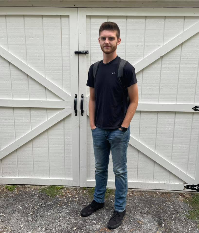 Handsome guy standing in front of a door